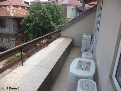 a balcony with a toilet on the side of a building at Guest House Liliya in Sozopol