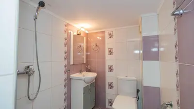 a bathroom with a toilet and a sink and a shower at Paradise Sarafovo Beach in Burgas City