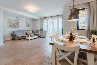 a dining room and living room with a table and chairs at Созопол Sozopol- SOZOPOLIS - MORE SUN 2В in Sozopol