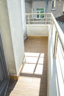 a balcony with a wooden floor and a railing at GRAND APARTMENT BOGORIDI - top center near to sea and sea garden in Burgas City