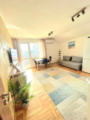 a living room with a couch and a table at Centro apart in Burgas City