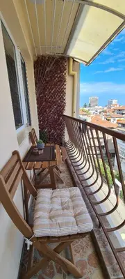 a balcony with a table and chairs on a balcony at Centro apart in Burgas City