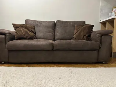 a brown couch sitting in a living room at Central Apartment in Varna in Varna City