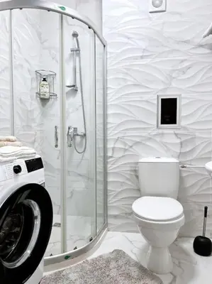 a white bathroom with a toilet and a shower at Seaside apartment Tyndzha in Pomorie