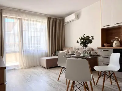 a kitchen and living room with a table and chairs at Seaside apartment Tyndzha in Pomorie