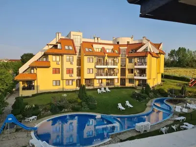 a large building with a pool in front of it at Apartment Oasis A4 Kamchia in Bliznatsi