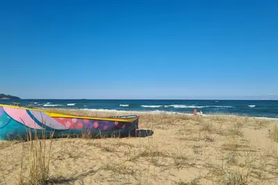 a boat sitting on the beach near the ocean at Apartment Oasis A4 Kamchia in Bliznatsi