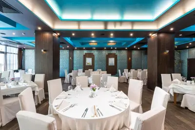 a banquet hall with white tables and white chairs at Garden of Eden Sea and Pool View in Sveti Vlas