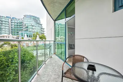 a balcony with a table and a view of a city at Paradise Apartments Primorsko in Primorsko