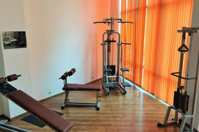 a room with three treadmills and exercise machines at Paradise Apartments Primorsko in Primorsko