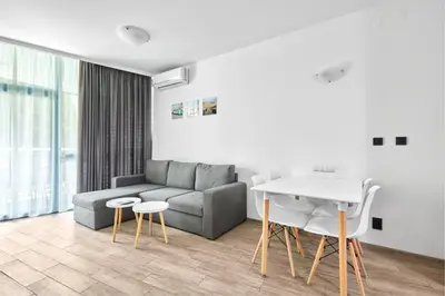 a living room with a couch and a table at Paradise Apartments Primorsko in Primorsko