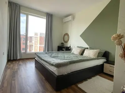 a bedroom with a large bed and a large window at Chic&Cozy Apartment in Nessebar in Nesebar
