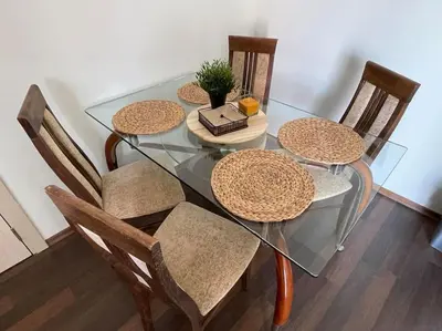 a glass dining table with chairs and a book on it at Chic&Cozy Apartment in Nessebar in Nesebar