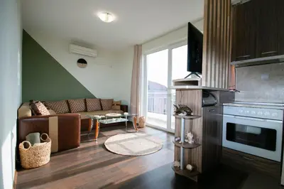 a living room with a couch and a tv at Chic&Cozy Apartment in Nessebar in Nesebar