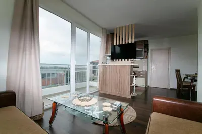 a living room with a glass table and a large window at Chic&Cozy Apartment in Nessebar in Nesebar