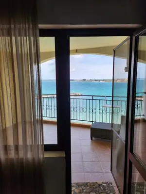 a room with a view of the ocean from a balcony at Úchvatný výhled na moře in Aheloy