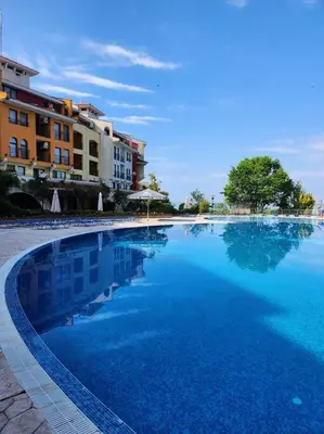 a large pool of blue water in front of buildings at Úchvatný výhled na moře in Aheloy