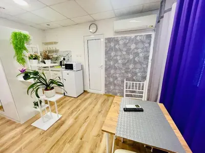 a living room with a table and a kitchen at Studio 21 in Varna City