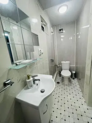 a white bathroom with a sink and a toilet at Studio 21 in Varna City