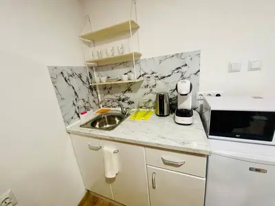 a small kitchen with a sink and a microwave at Studio 21 in Varna City