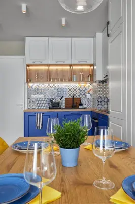 a kitchen with a wooden table with wine glasses at The Swing in Burgas City