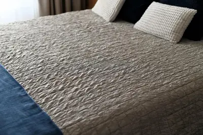 a bed with white sheets and pillows on it at The Swing in Burgas City