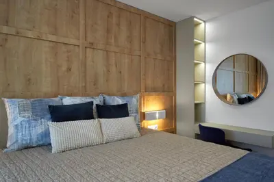 a bedroom with a bed with a large wooden headboard at The Swing in Burgas City