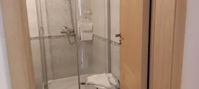 a shower with a glass door next to a toilet at Sunny Fort apartments Sanny Beach Parking Free in Sunny Beach