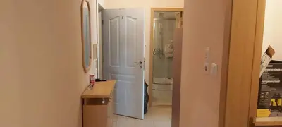 a bathroom with a sink and a door to a toilet at Sunny Fort apartments Sanny Beach Parking Free in Sunny Beach