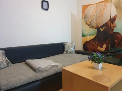 a living room with a couch and a painting at Sunny Fort apartments Sanny Beach Parking Free in Sunny Beach
