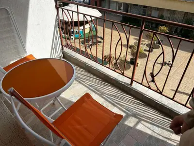 a balcony with a table and chairs and a playground at Апартамент Александър in Sunny Beach