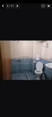 a bathroom with a toilet and a sink at Апартамент Александър in Sunny Beach
