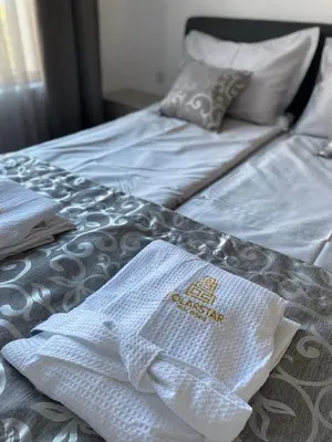 a bed with white towels on top of it at Mary Beach Resort Premium Apartments in Sveti Vlas