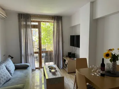 a living room with a couch and a table at Complex Compass in Sveti Vlas