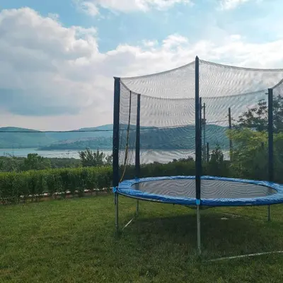 a trampoline in the grass with a white cover at Eco Lodge St Ignatius Еко лодж Игнажден in Debelets