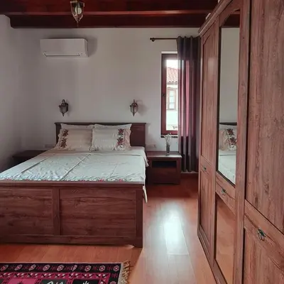 a bedroom with a bed and a large mirror at Eco Lodge St Ignatius Еко лодж Игнажден in Debelets