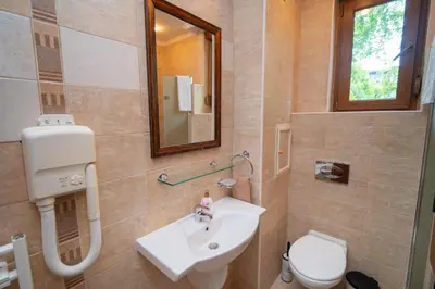 a bathroom with a sink and a toilet and a mirror at SeaRent Dream Home in Santa Marina - 2 bedrooms, 2 baths and a HUGE terrace in Sozopol