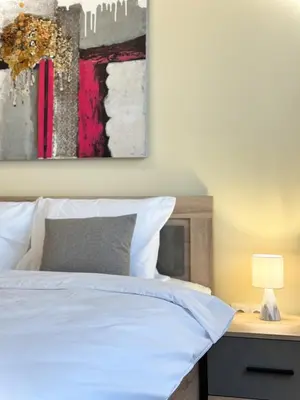 a bedroom with a bed and a painting on the wall at Restful Apartment for 4 Guests in Burgas in Burgas City