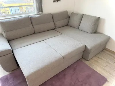 a brown couch in a room with a window at Restful Apartment for 4 Guests in Burgas in Burgas City