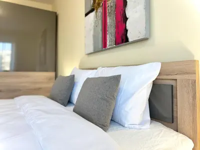 a bedroom with a bed with white sheets and pillows at Restful Apartment for 4 Guests in Burgas in Burgas City