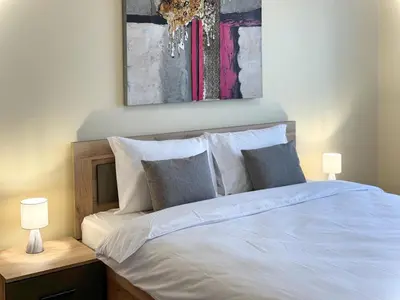 a bedroom with a white bed with two lamps at Restful Apartment for 4 Guests in Burgas in Burgas City