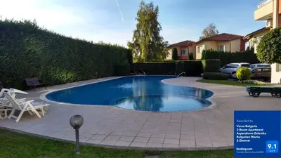a swimming pool in a yard next to a house at Varna Bulgaria 2-Room Apartment Asparuhovo Zelenika Bulgarien Warna 2-Zimmer in Galata
