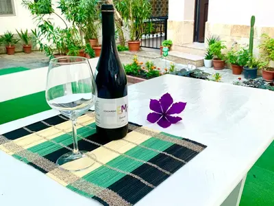 a bottle of wine and a glass on a table at Sea View Rooms Briz in Nesebar