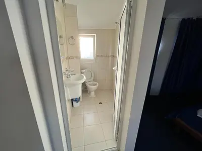 a bathroom with a toilet and a sink at Sea View Rooms Briz in Nesebar
