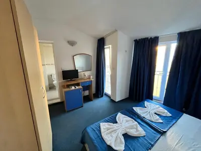 a hotel room with a bed with towels on it at Sea View Rooms Briz in Nesebar