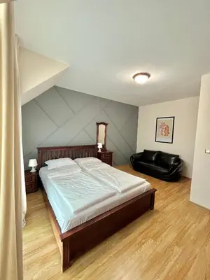 a bedroom with a large bed in a room at Golden Hermes Apartments in Sunny Beach