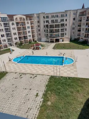 a large swimming pool in front of a large building at Ред хаус in Sunny Beach
