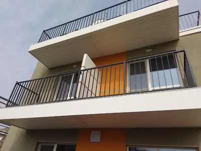 a balcony on the side of a building at July's Guest House in Primorsko