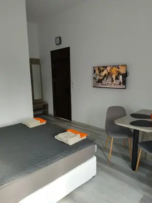 a room with a bed and a table and a chair at July's Guest House in Primorsko