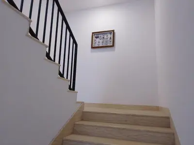 a stairway with a framed picture on the wall at July's Guest House in Primorsko